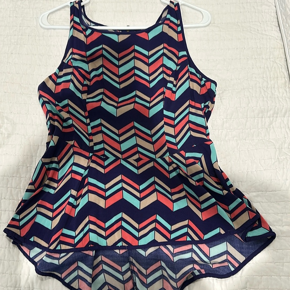 Beautiful colorful blouse with zipper down back.  Peplum style shirt.
